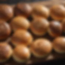 Assortment of low carb buns on a wooden board, showcasing their variety and texture.
