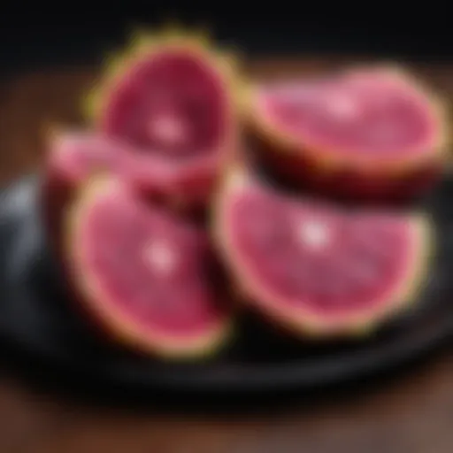 Exotic dragon fruit slices on a black plate