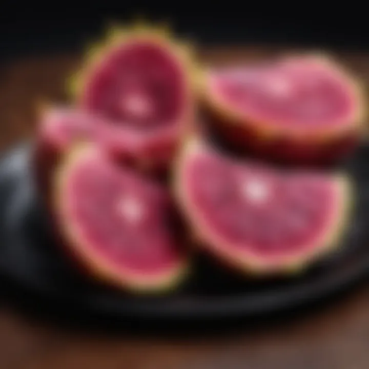 Exotic dragon fruit slices on a black plate