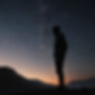 Silhouette of a man standing under a night sky