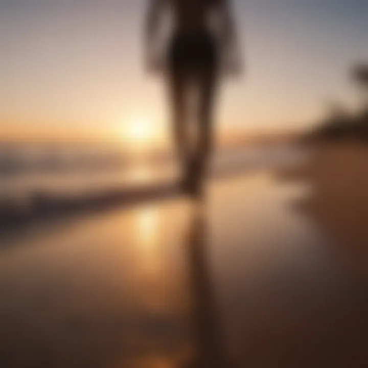 Silhouette of a person walking towards a sunset on a beach